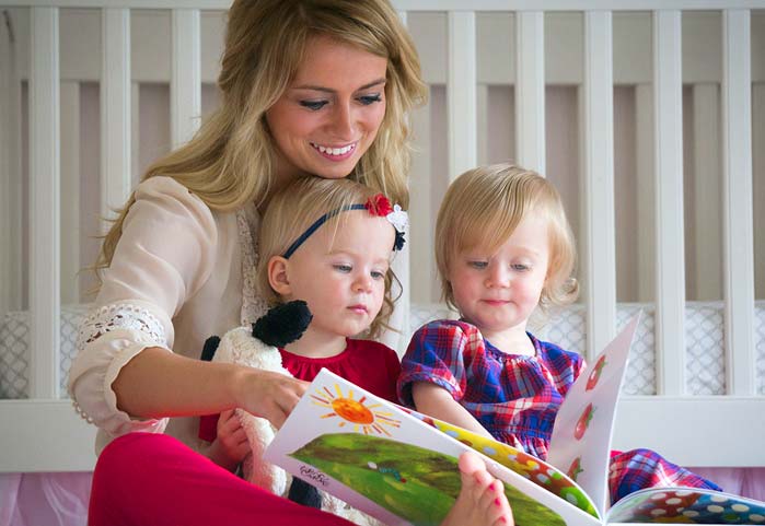 Photo of a young nanny with two small children